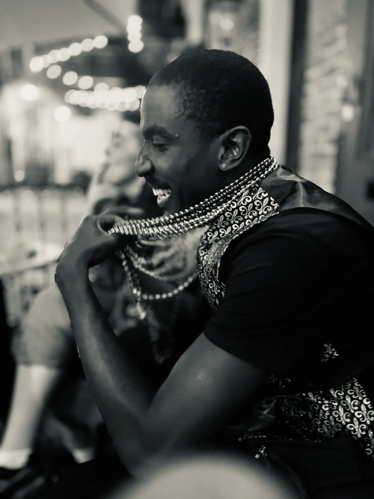Untitled (Festival Lights), black and white photograph by Mathieu: festival beads and lights after dark